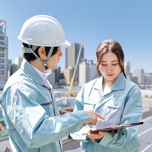 机の上にある書類を元に話している様子